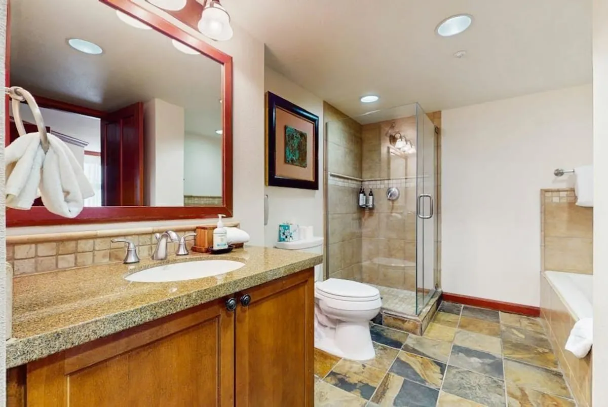 Two-bedroom corner suite — En suite bathroom; original listing photograph