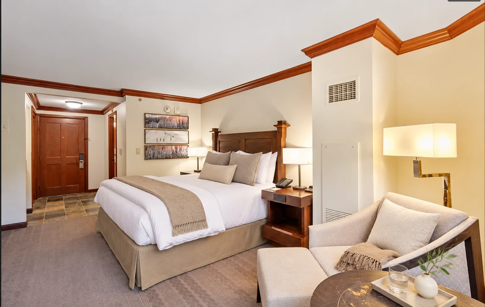 Two-bedroom corner suite — Second private king bedroom with a sitting area and en suite bathroom; digitally styled linens and accessories