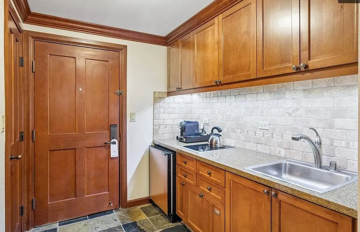Two-bedroom corner suite — Kitchenette, another view; original listing photograph