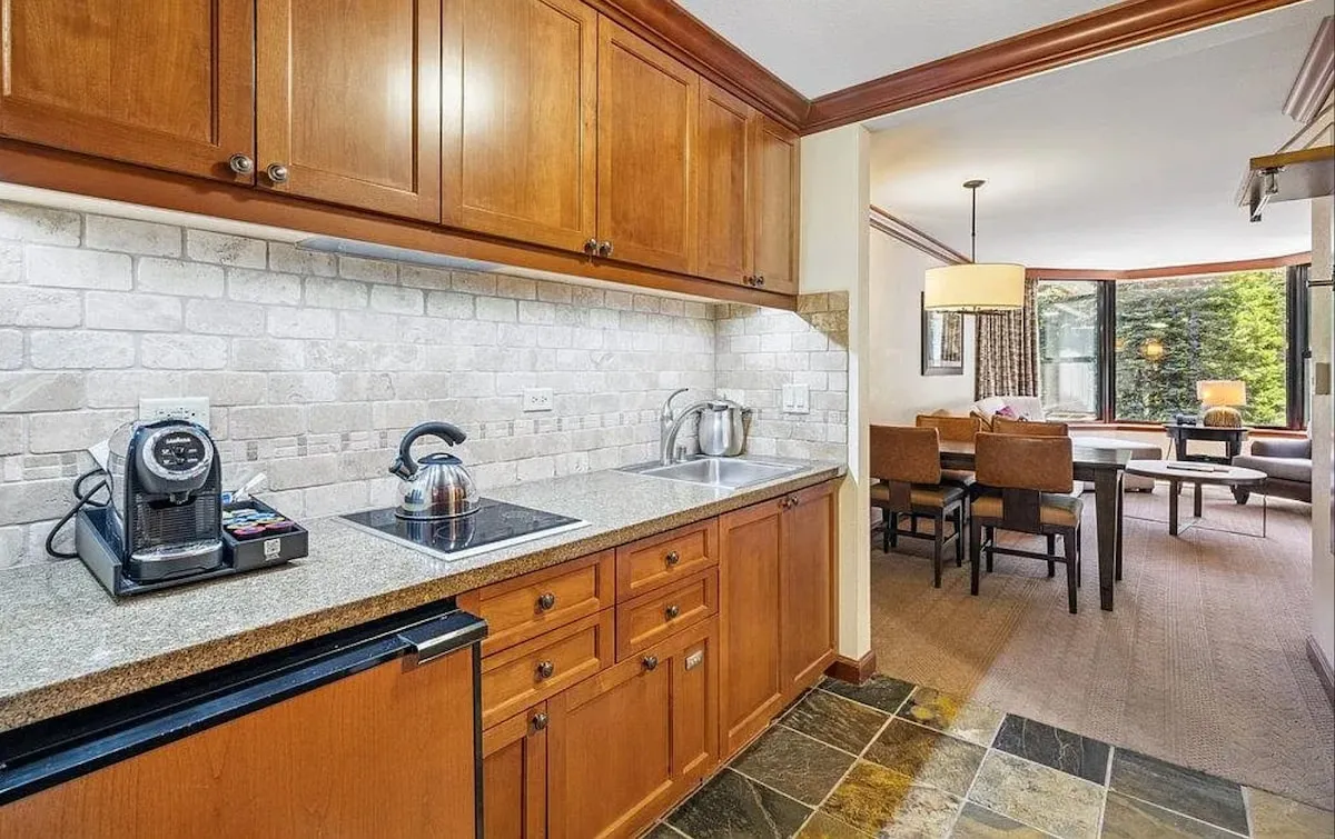 Two-bedroom corner suite — Kitchenette & dining outlook; original listing photograph