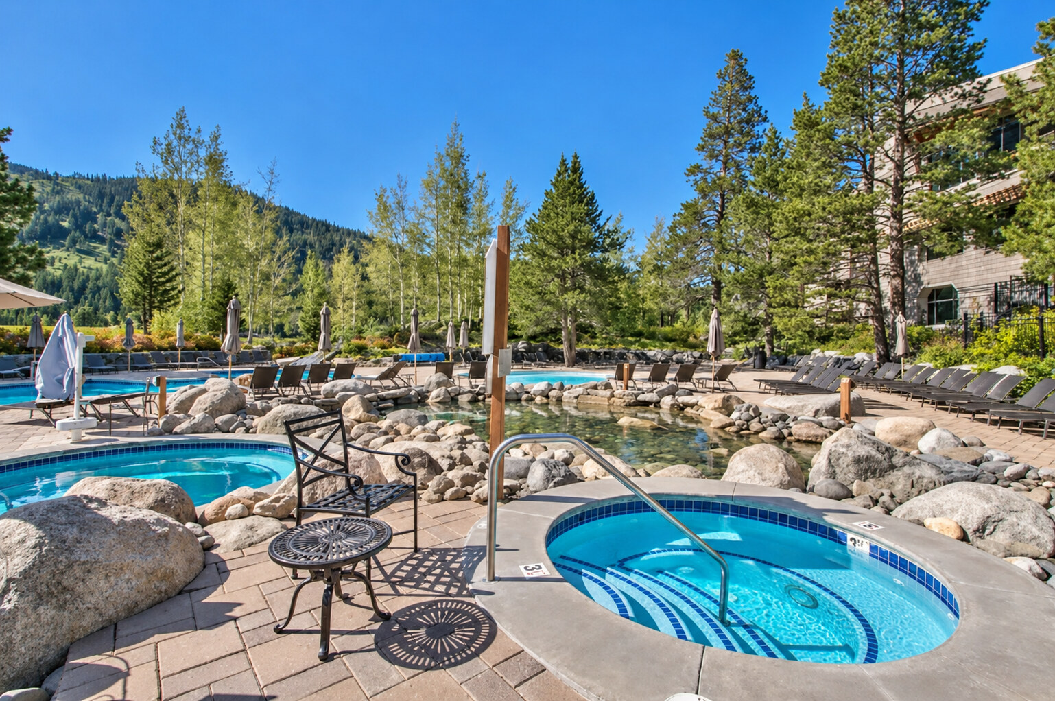 Resort pool deck and hot tub in summer
