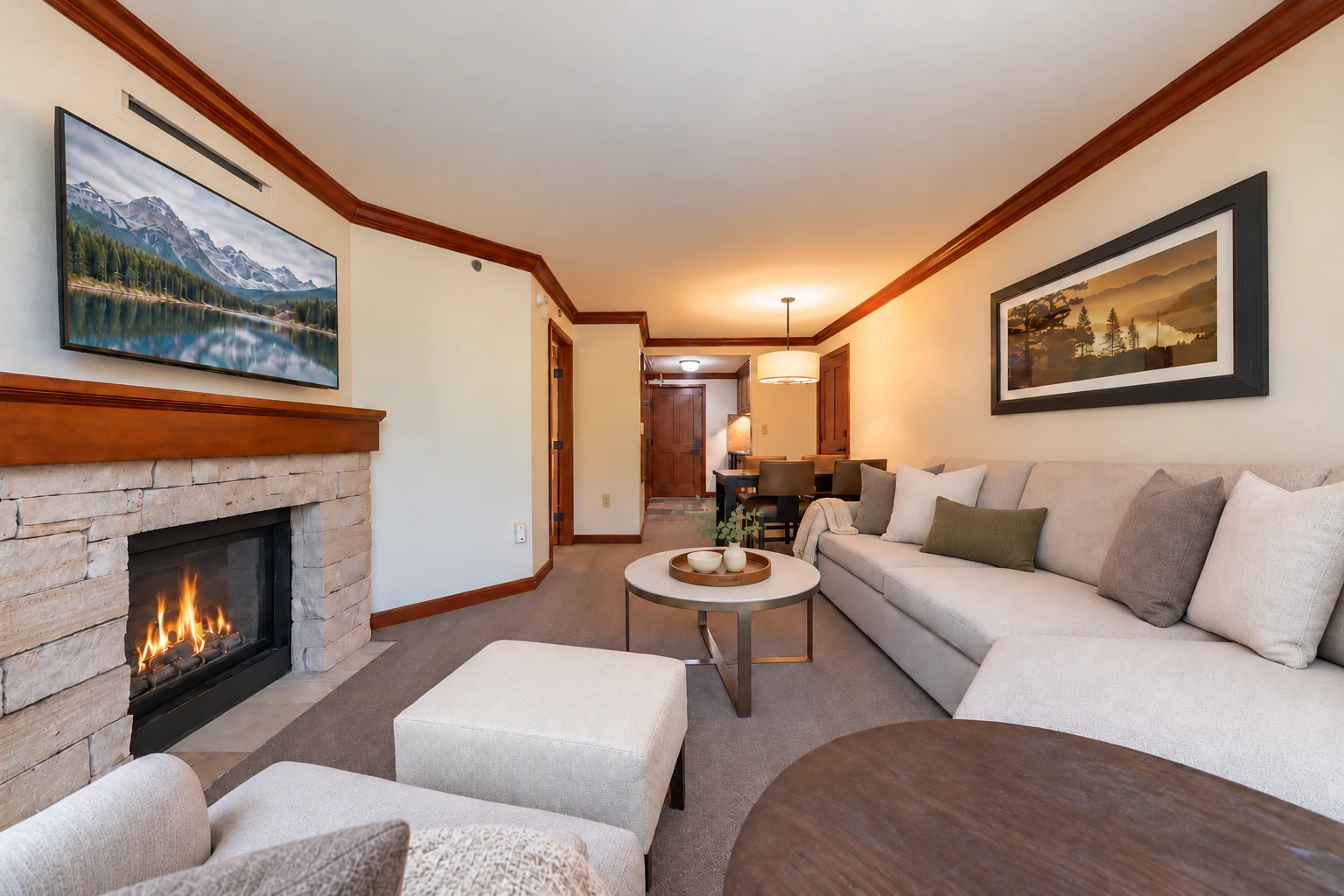 One-bedroom suite — Living room & fireplace; digitally styled linens and accessories